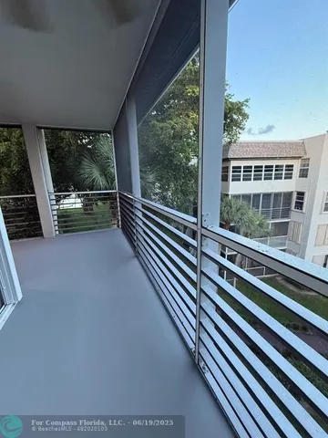 a view of a balcony with chairs