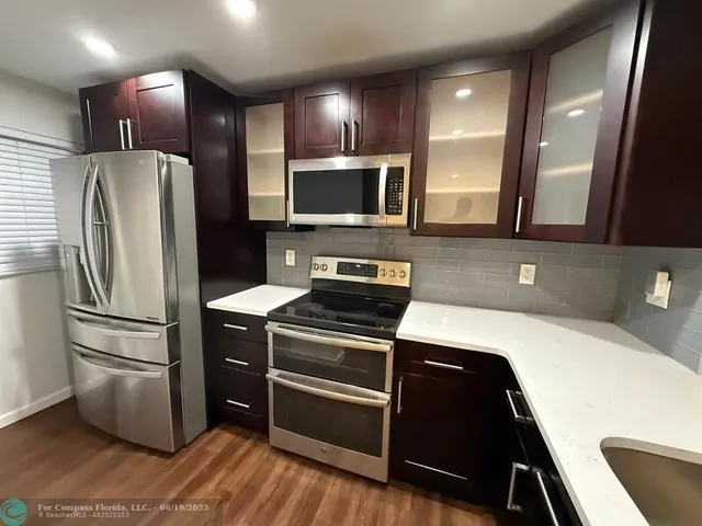 a kitchen with a refrigerator sink and microwave