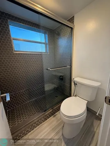 a bathroom with a toilet and a shower