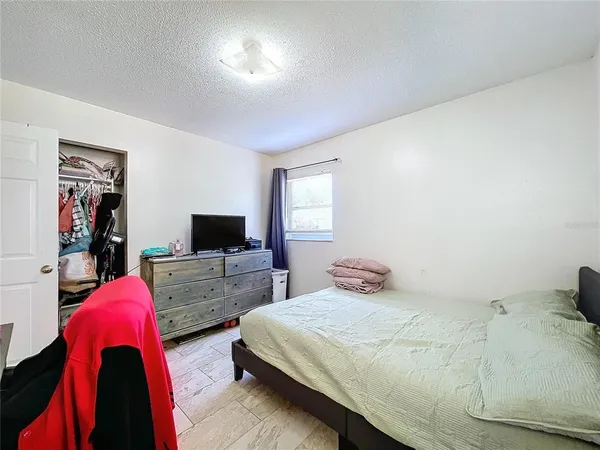 a bedroom with a bed and window