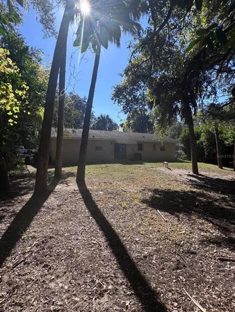 a view of a yard with wooden fence