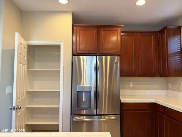 a kitchen with a refrigerator and cabinets