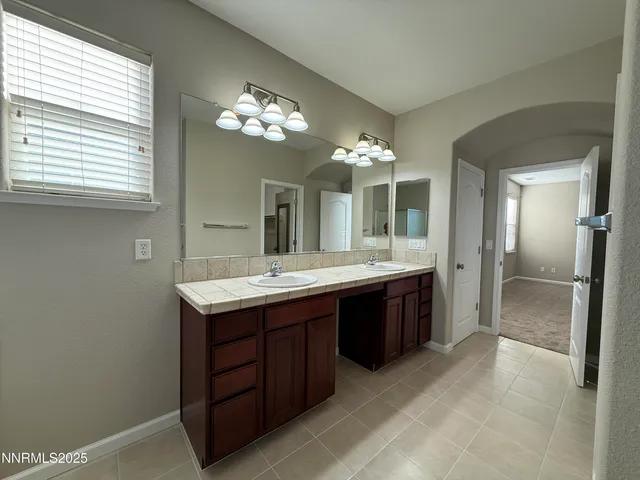 a bathroom with a sink vanity and a mirror