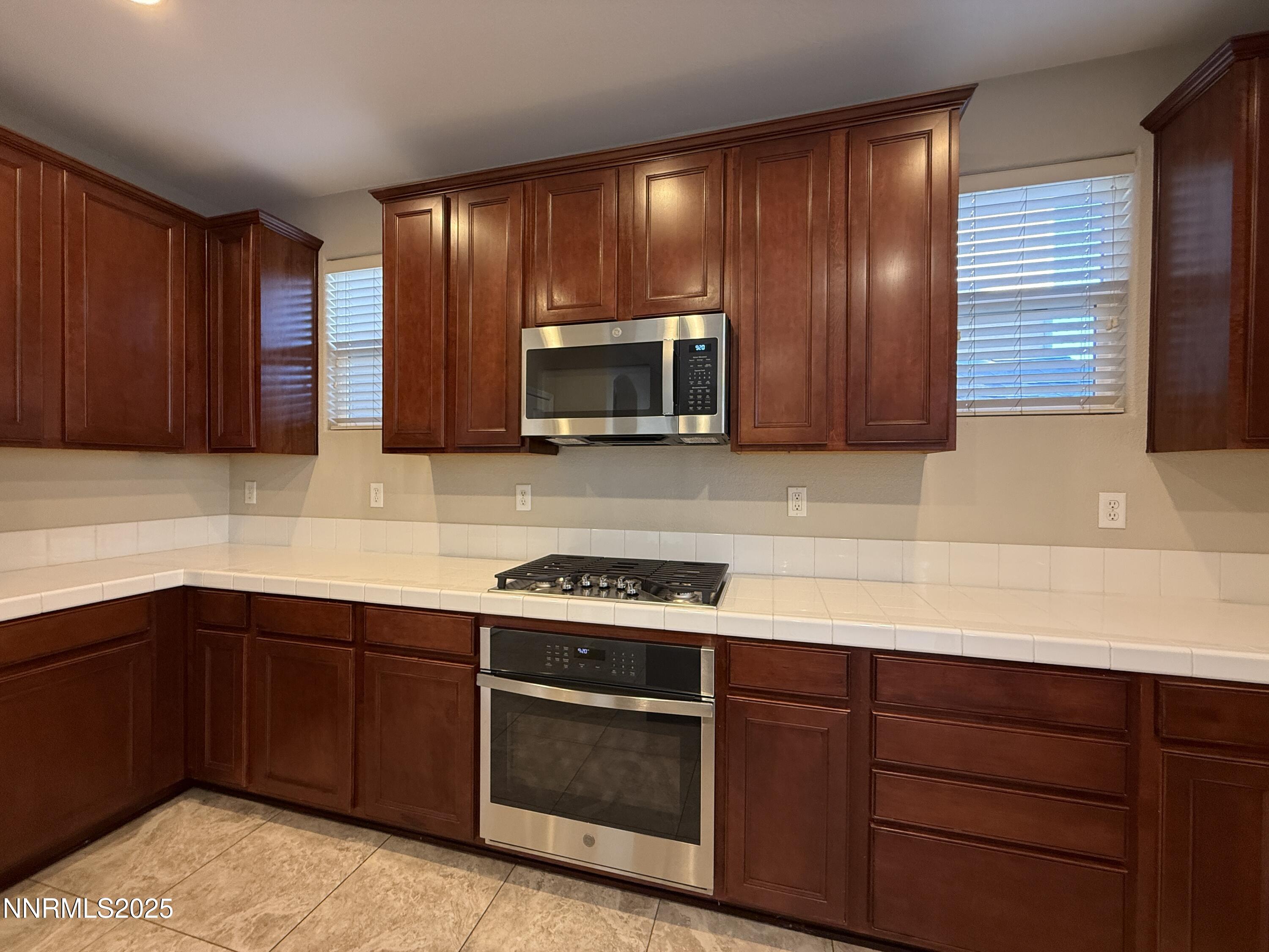 435 Stradella Court Reno, NV 89521 - Photo 2 of 33 a kitchen with stainless steel appliances granite countertop wooden cabinets and a sink