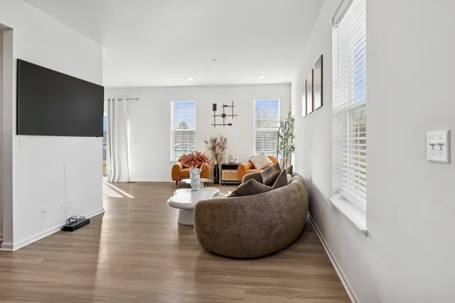 a living room with furniture and a flat screen tv