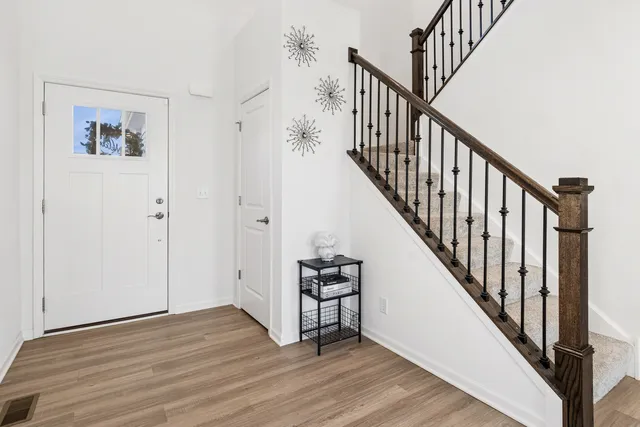 a view of an entryway with wooden floor