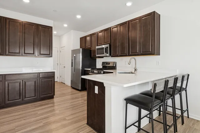 a kitchen with a sink a microwave and cabinets