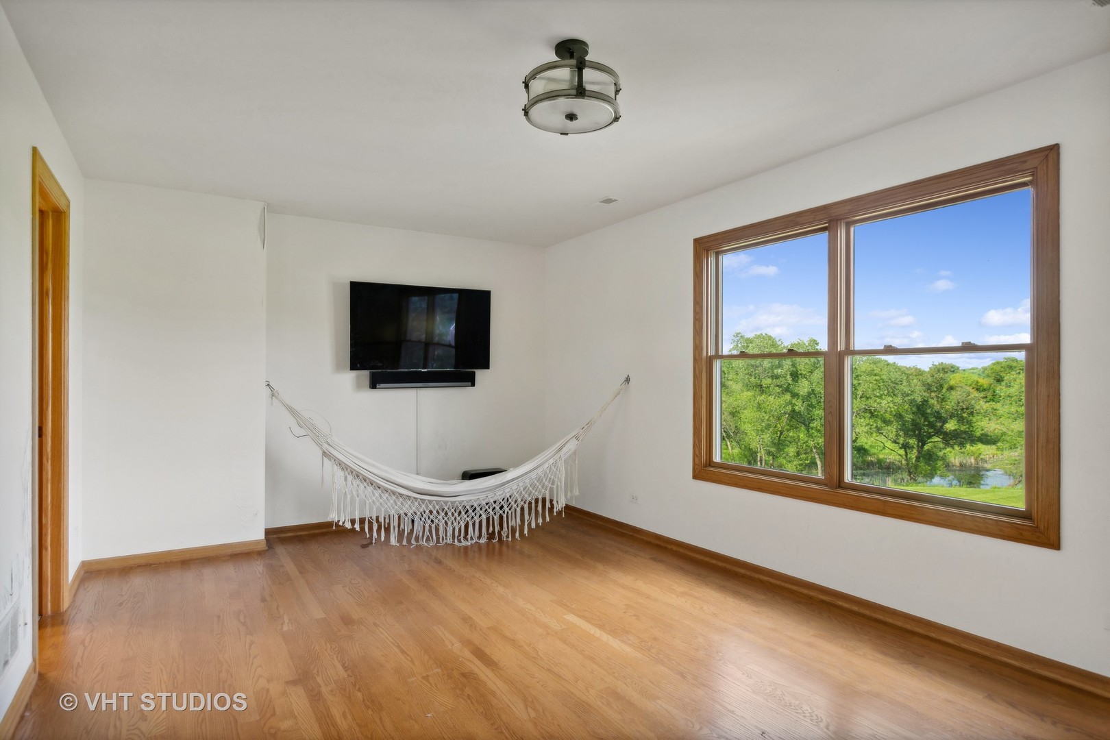 41W640 Burlington Road St. Charles, IL 60175 - Photo 18 of 39 a living room with furniture a flat screen tv and a window