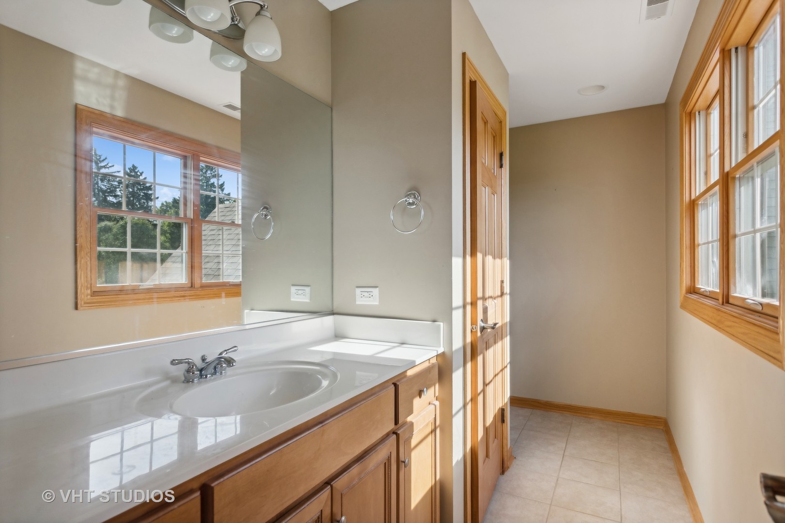 41W640 Burlington Road St. Charles, IL 60175 - Photo 21 of 39 a bathroom with a granite countertop sink and a window