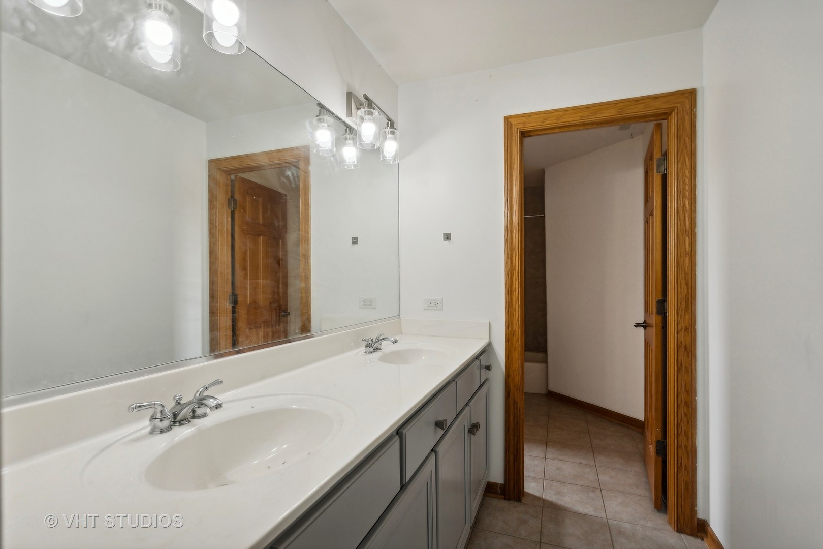 41W640 Burlington Road St. Charles, IL 60175 - Photo 23 of 39 a bathroom with a double vanity sink and a mirror