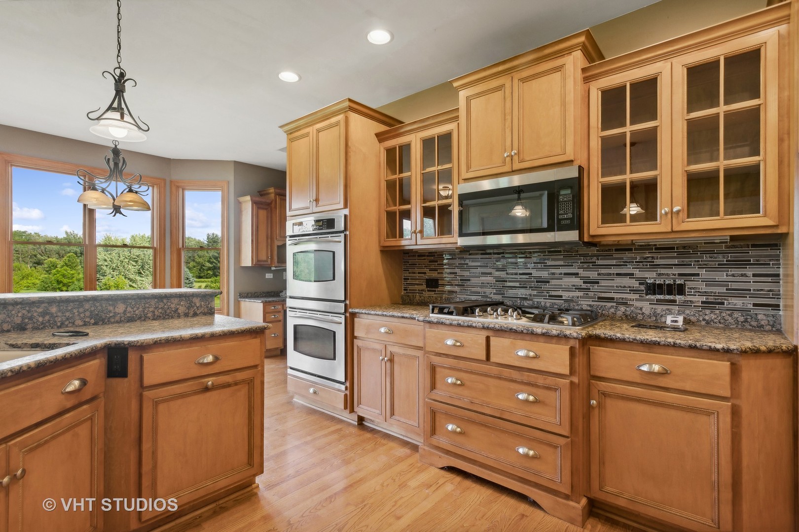 41W640 Burlington Road St. Charles, IL 60175 - Photo 6 of 39 a kitchen with stainless steel appliances granite countertop wooden cabinets and a stove top oven