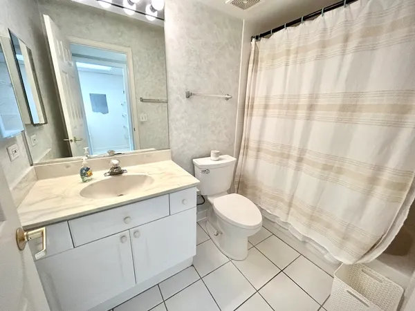 a spacious bedroom with a bed and a window