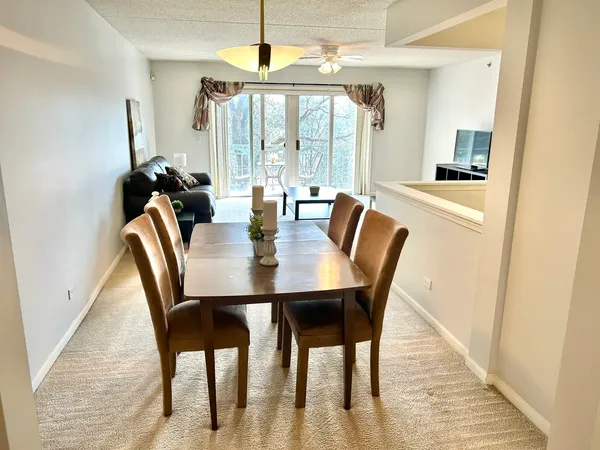 a dining room with furniture and window