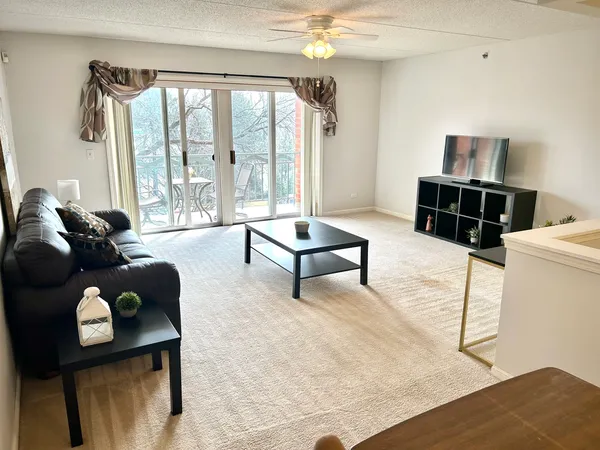a living room with furniture and a floor to ceiling window