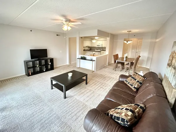 a living room with furniture and kitchen view