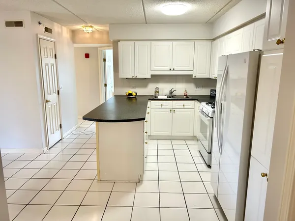 a kitchen with stainless steel appliances a refrigerator sink and cabinets