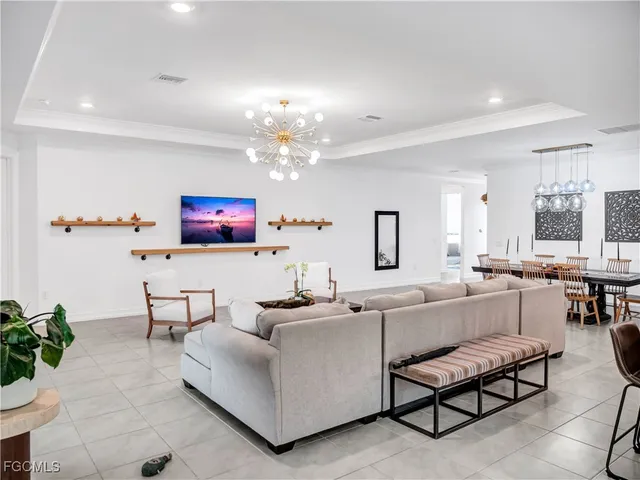 a living room with furniture and a chandelier