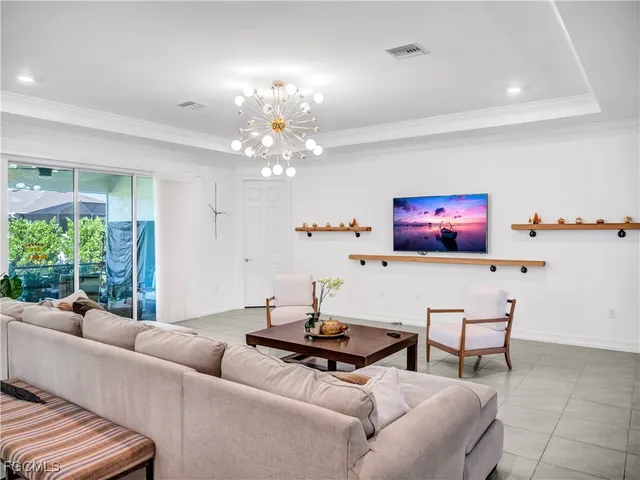 a living room with furniture and a chandelier