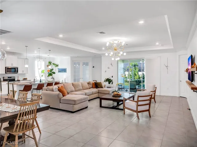 a living room with furniture and a chandelier