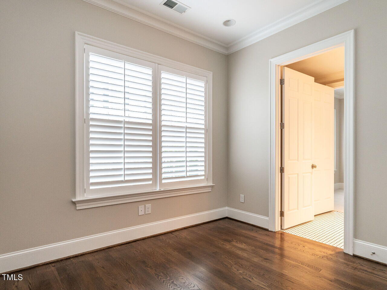 2017 Fairview Road, Unit 100 Raleigh, NC 27608 - Photo 30 of 32 a view of an empty room with wooden floor and a window
