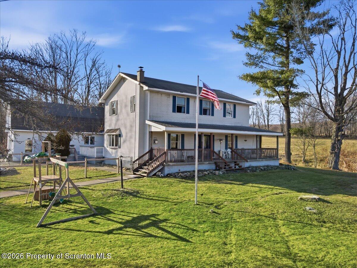 a view of a house with a yard patio and sitting area
