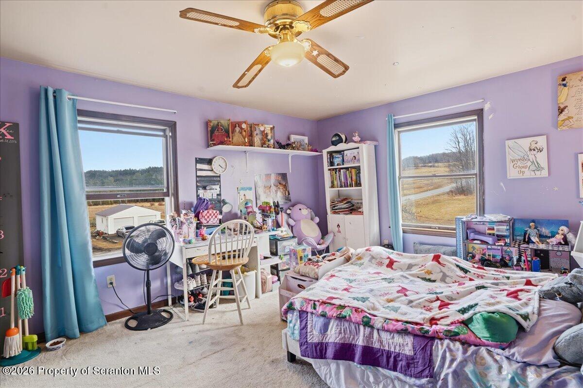 2909 Potter Hill Road Thompson, PA 18465 - Photo 54 of 80 a bedroom that has a bed and a chandelier