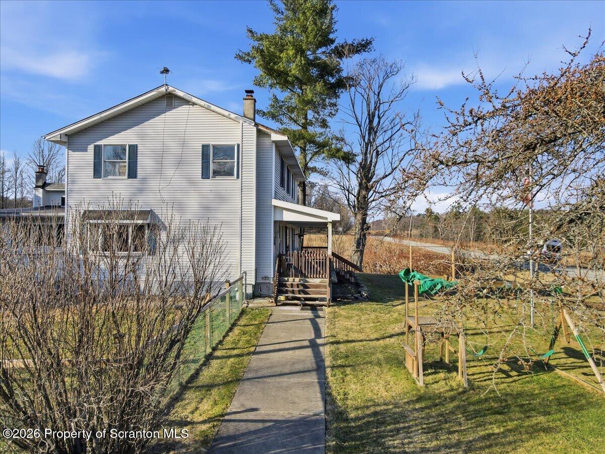 2909 Potter Hill Road Thompson, PA 18465 - Photo 66 of 80 a front view of a house with a yard