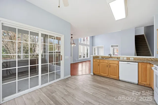 a kitchen with granite countertop a stove and a sink
