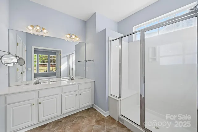 a bathroom with a double vanity sink and mirror