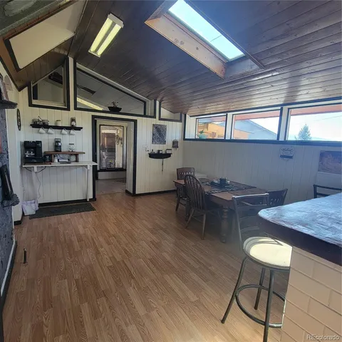 a dining room with furniture and wooden floor