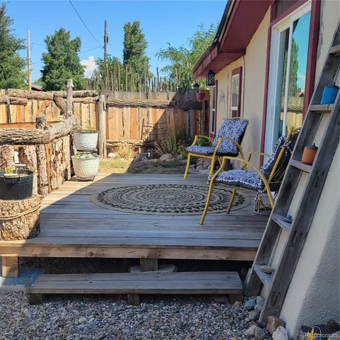 a view of a backyard with sitting area