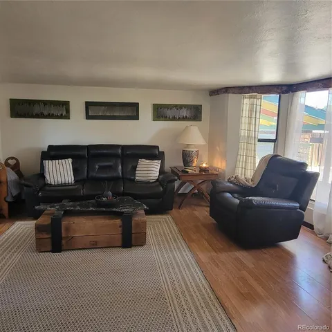 a living room with furniture a fireplace and a potted plant