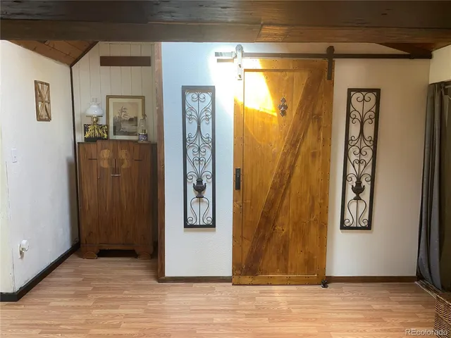 a view of a door and wooden floor