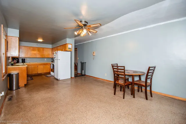 a view of a dining room with furniture and chandelier fan