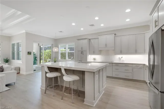 a kitchen with kitchen island a sink table and chairs