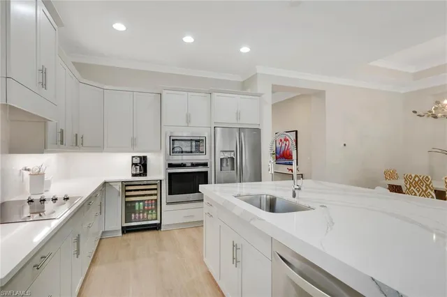 a kitchen with stainless steel appliances sink a microwave and cabinets