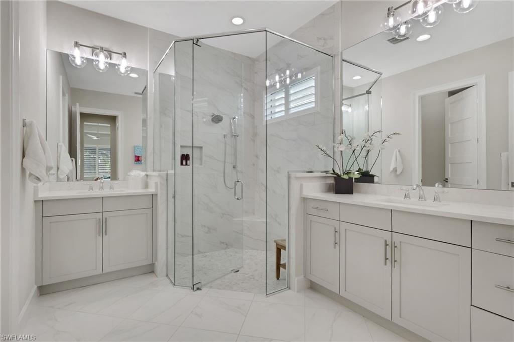 6253 Antigua Way Naples, FL 34113 - Photo 17 of 41 a bathroom with a shower sink and mirror