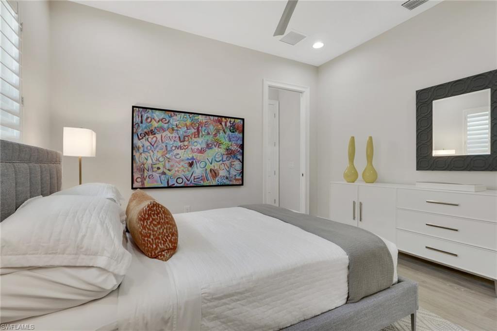 6253 Antigua Way Naples, FL 34113 - Photo 18 of 41 a bedroom with a bed and a painting on the wall
