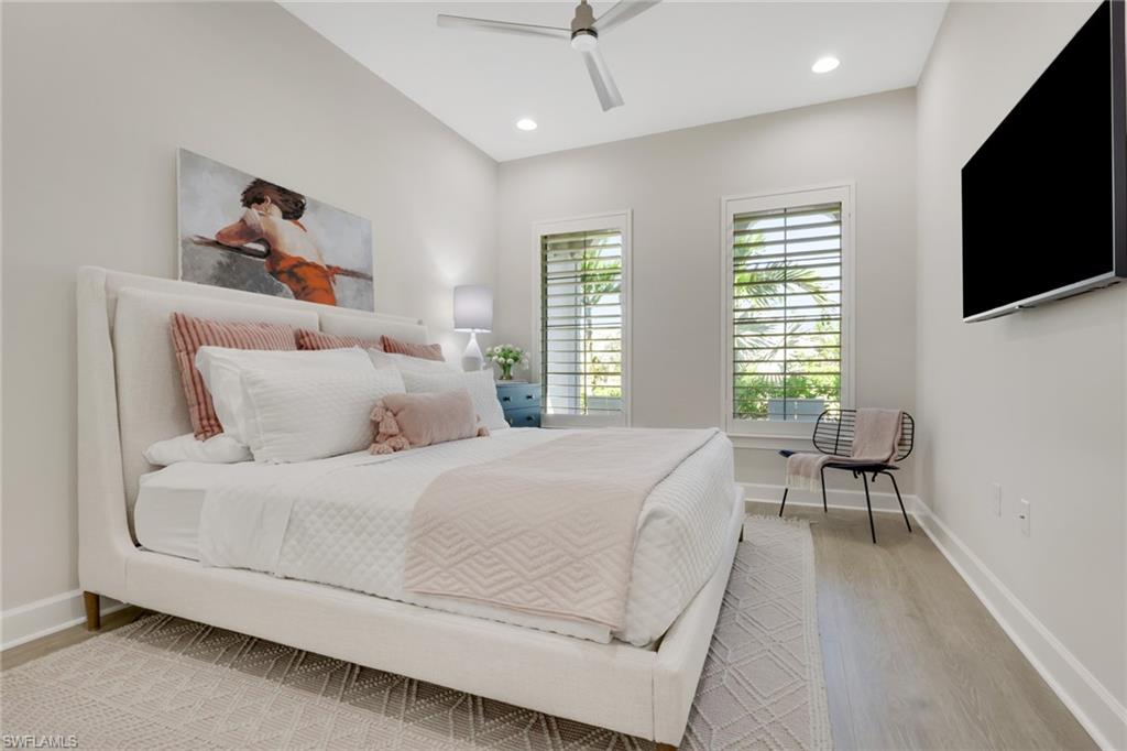 6253 Antigua Way Naples, FL 34113 - Photo 20 of 41 a bedroom with a bed and a flat screen tv