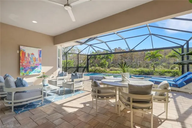 a view of a patio with table and chairs under an umbrella