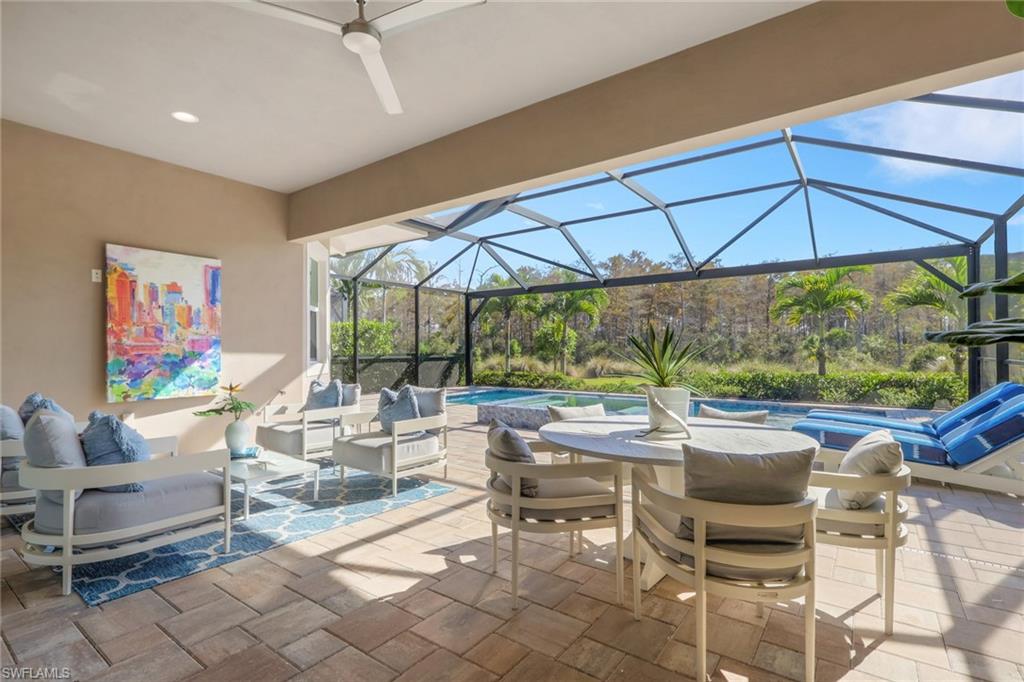 6253 Antigua Way Naples, FL 34113 - Photo 24 of 41 a outdoor space with furniture and umbrella