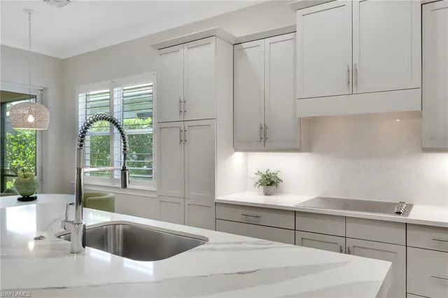 a kitchen with a sink and large window