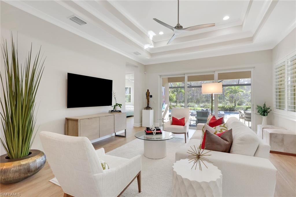 6253 Antigua Way Naples, FL 34113 - Photo 4 of 41 a living room with furniture and a flat screen tv
