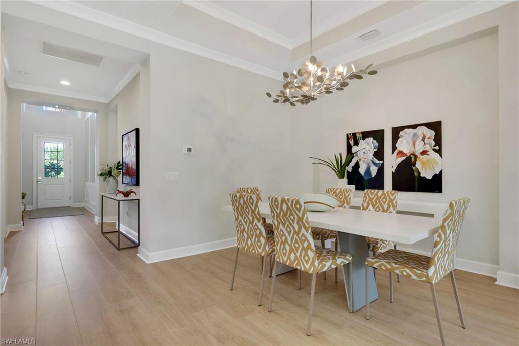 6253 Antigua Way Naples, FL 34113 - Photo 7 of 41 a view of a dining room with furniture and wooden floor
