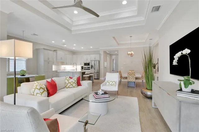 a living room with furniture and view of kitchen