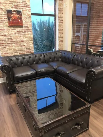 a blue bed sitting in a living room next to a window