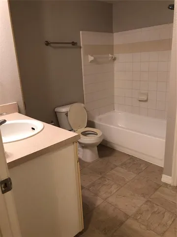 a bathroom with a sink a toilet and bathtub