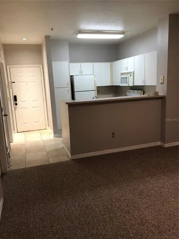 a kitchen with stainless steel appliances a refrigerator and a stove