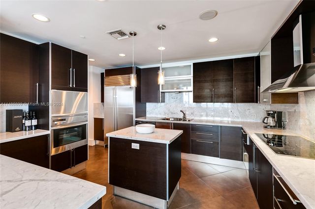 a kitchen with a sink a stove and a window