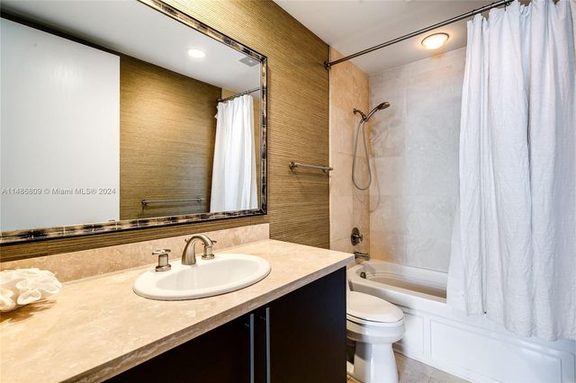 a bathroom with a shower and a sink